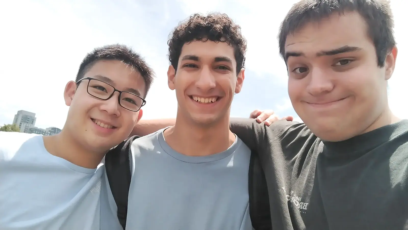 Daniel smiling outside with friends